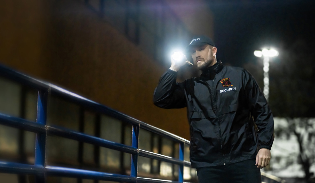 Security Guard shines his flashlight at night.